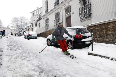 Skiers Take To Streets As Paris Comes Under Heavy Snows