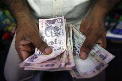 Rupee weakens on dollar short-covering; gains for second month