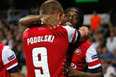 Podolski, Gervinho score as Arsenal win
