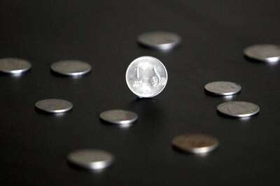 Rupee trims gains after RBI holds repo rate