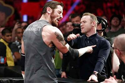Wayne Rooney slaps wrestler Wade Barrett during WWE Raw event